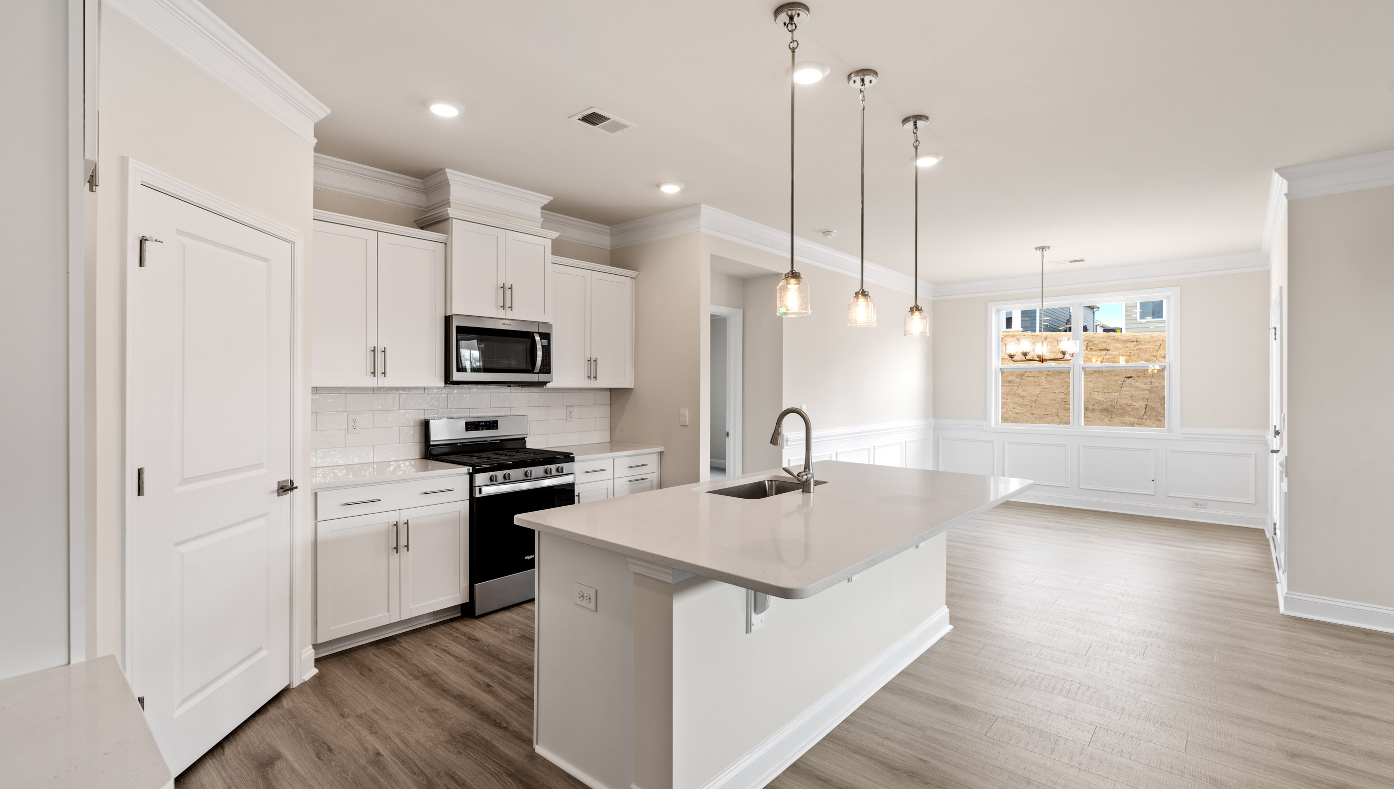Kitchen with island and quartz countertops.