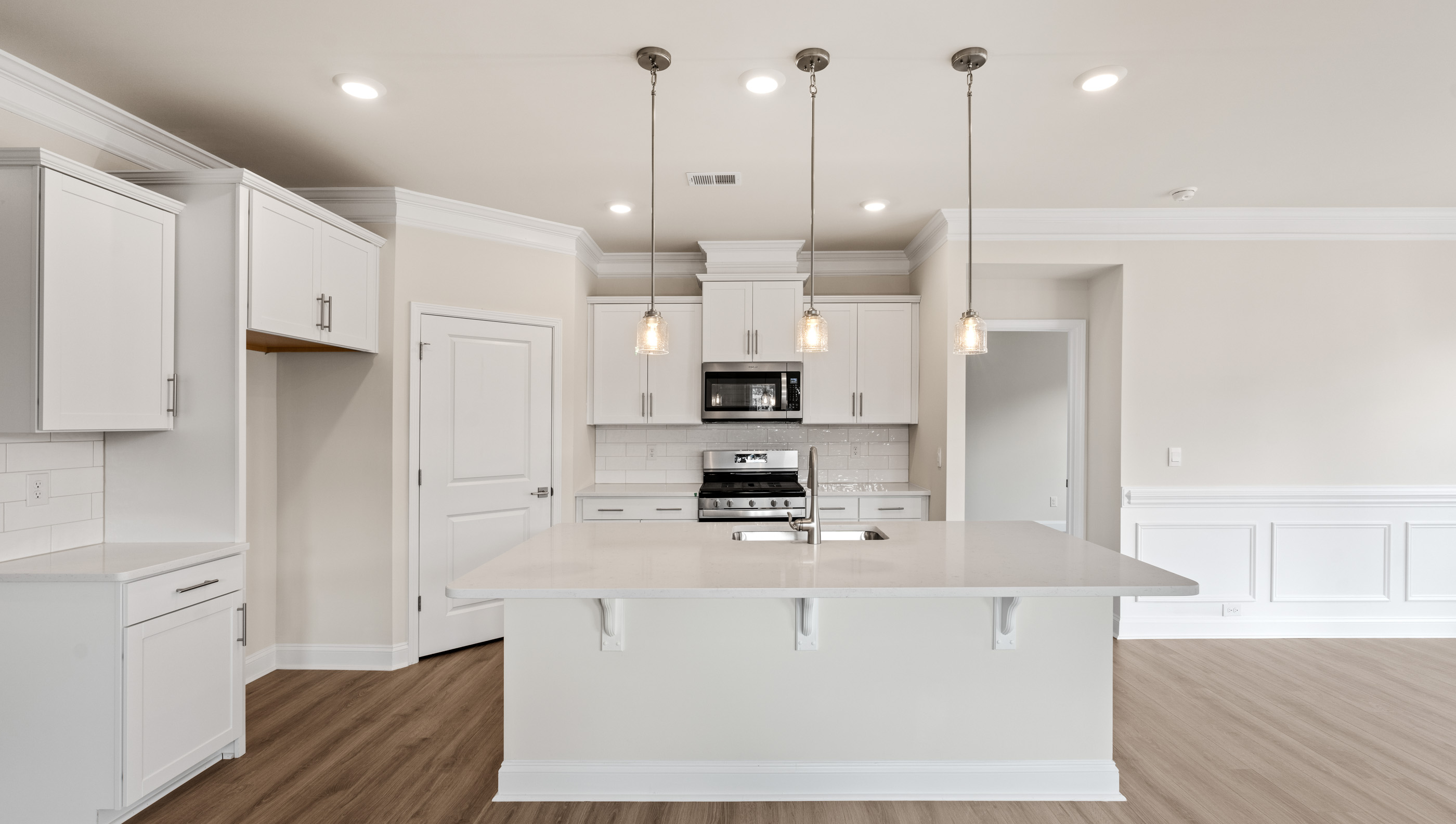 Kitchen with island and quartz countertops.