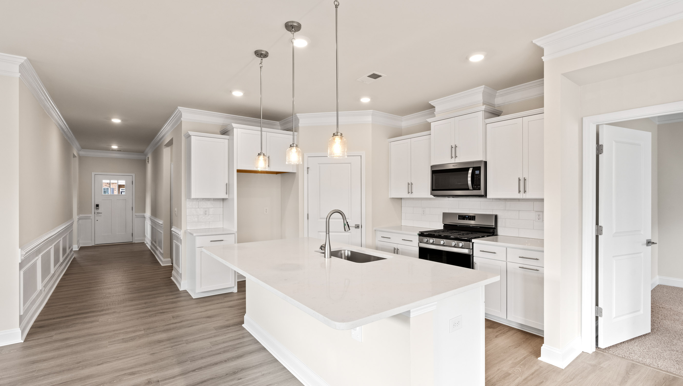 Kitchen with island and quartz countertops.