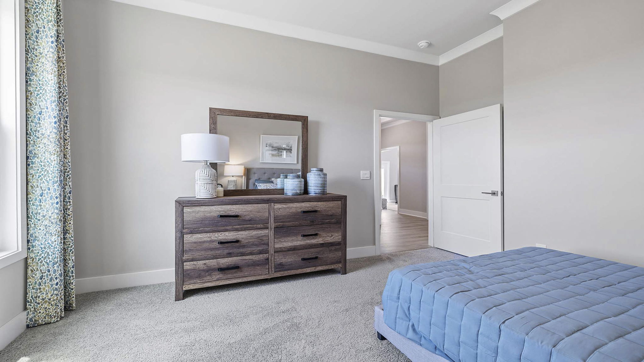 Bedroom with carpet and windows.