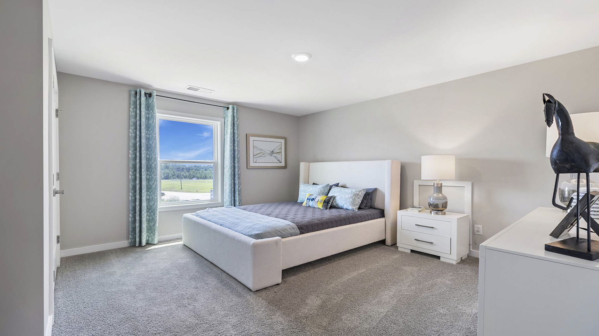 Bedroom with carpet and windows.