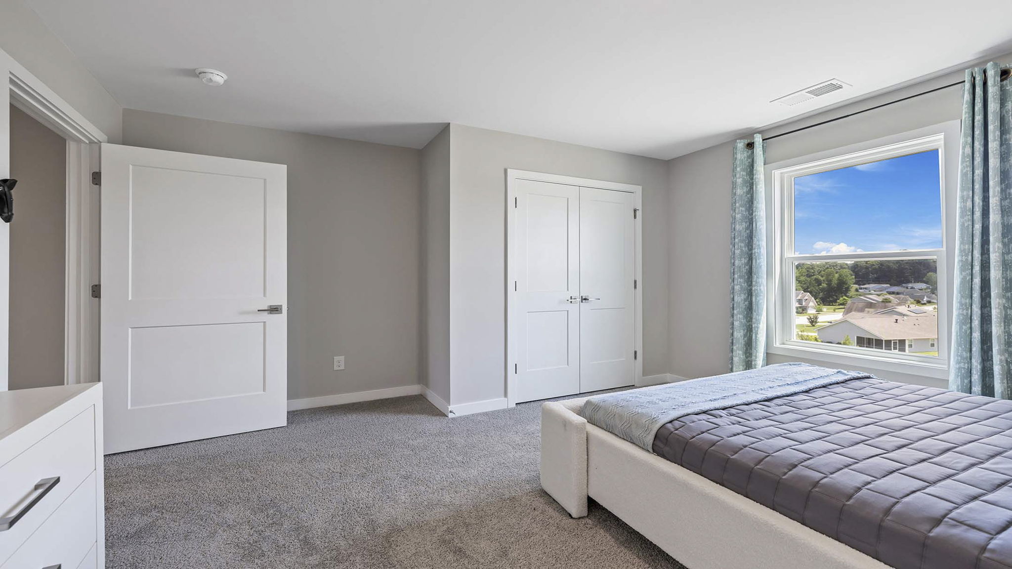 Bedroom with carpet and windows.