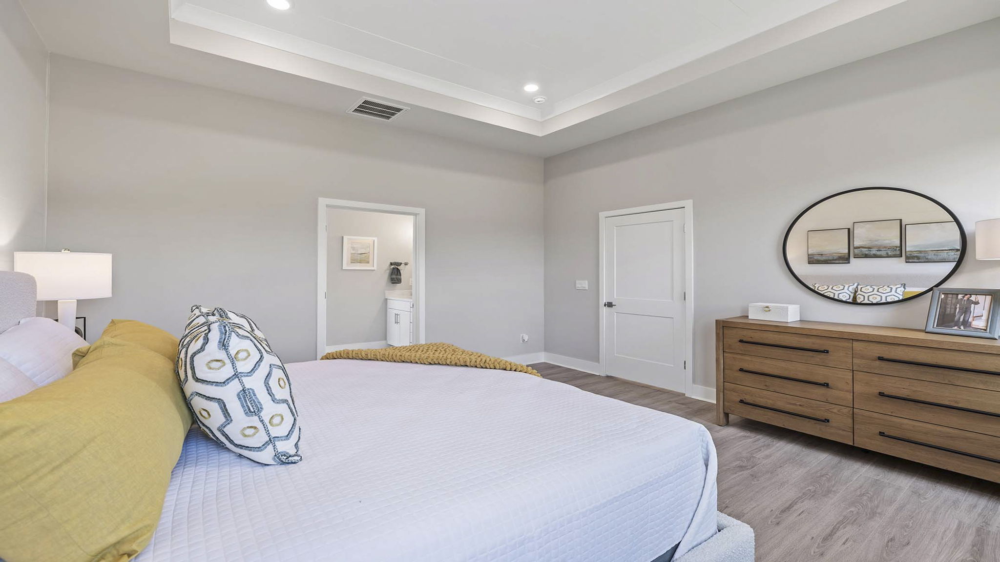 Primary bedroom with carpet and window.
