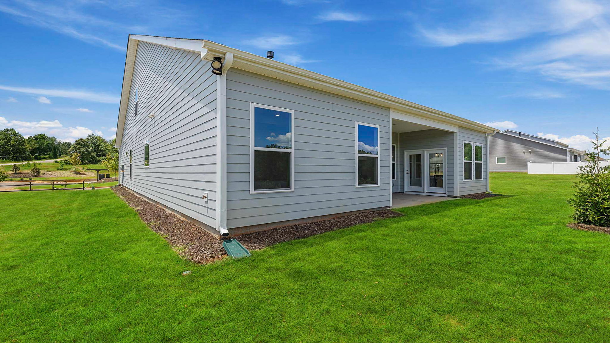 Back exterior with covered porch.