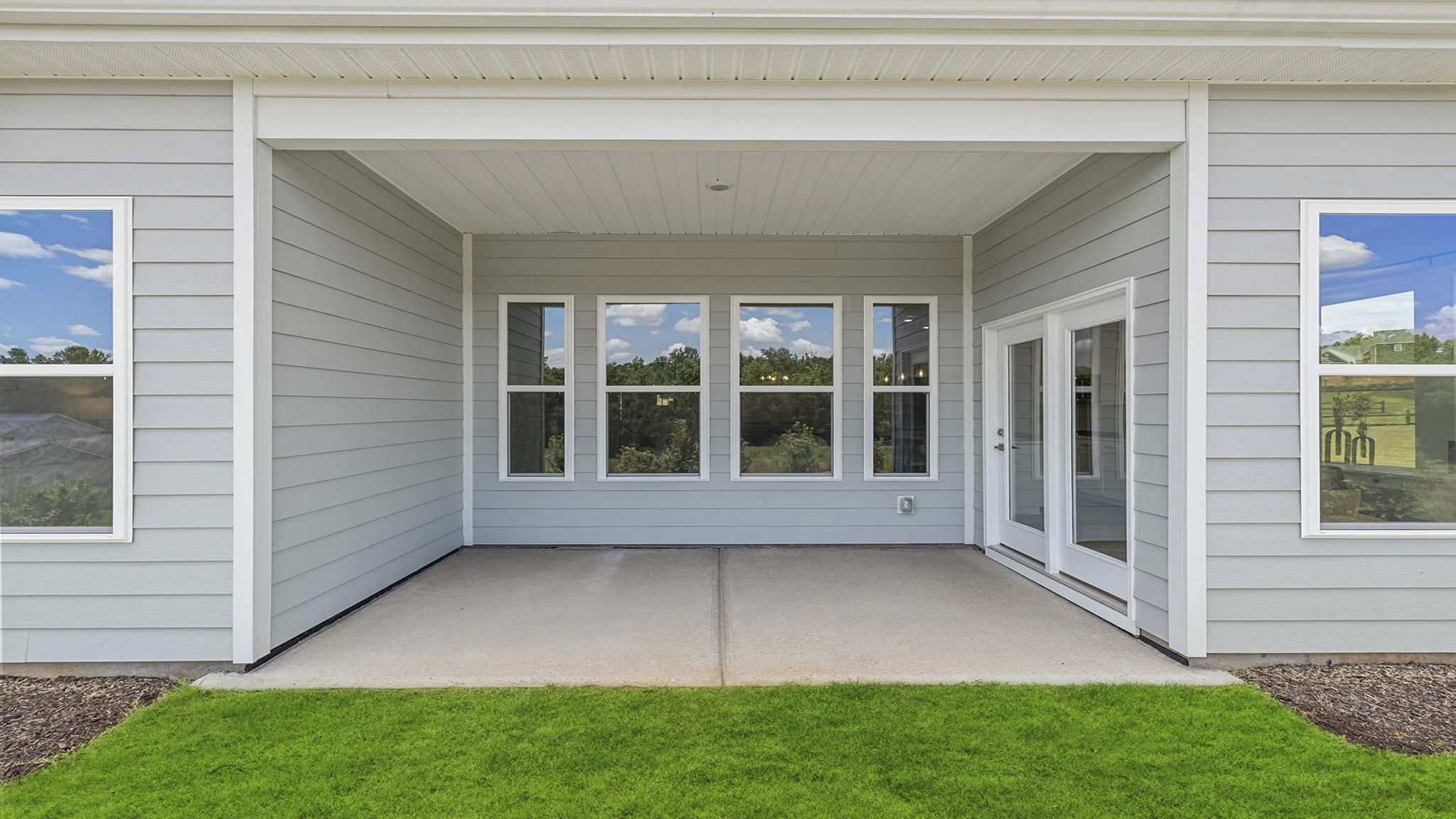 Back exterior with covered porch.