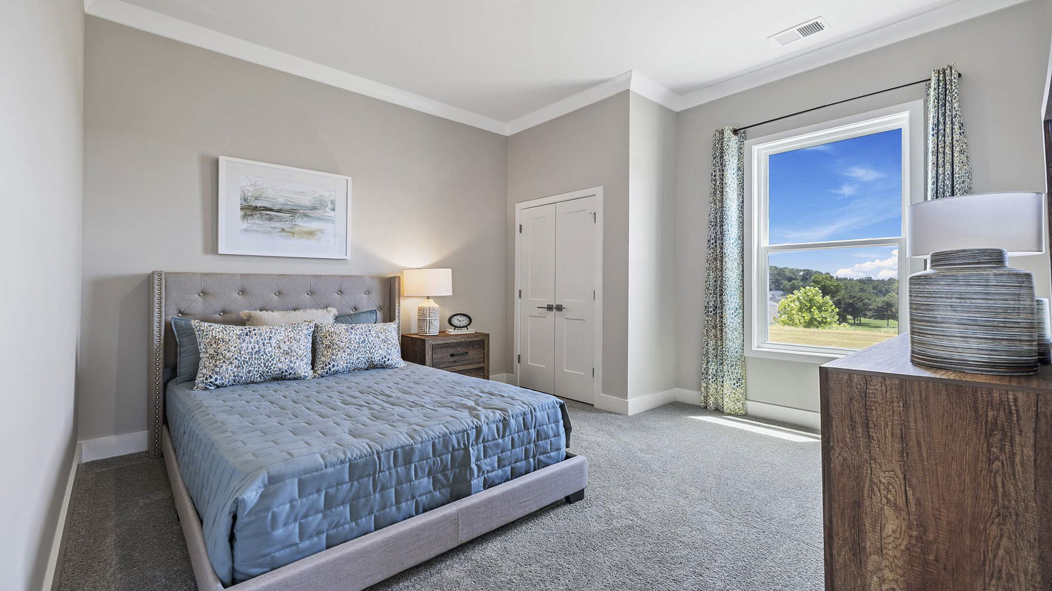 Bedroom with carpet and windows.