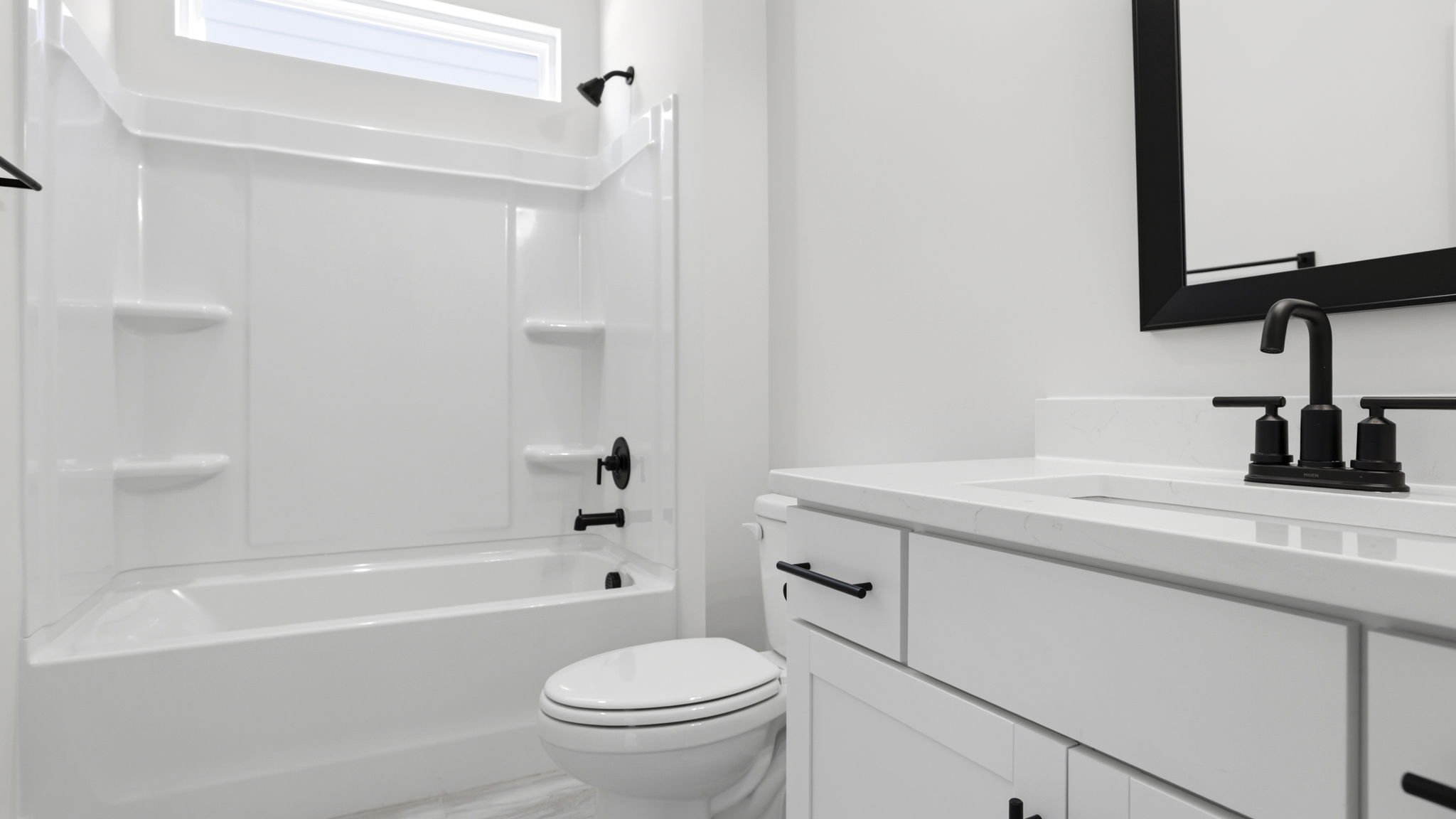 Hall bathroom with vanity and combination shower / tub.