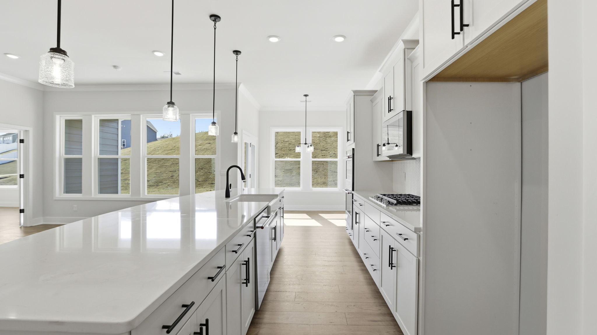 Kitchen and island have quartz countertops.