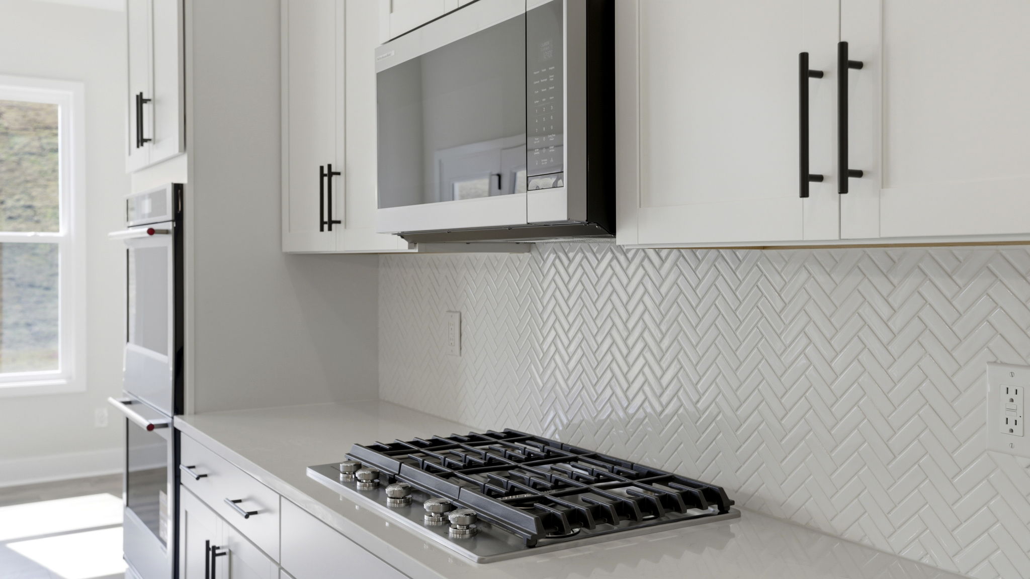 Stainless gas stove top and built in microwave.