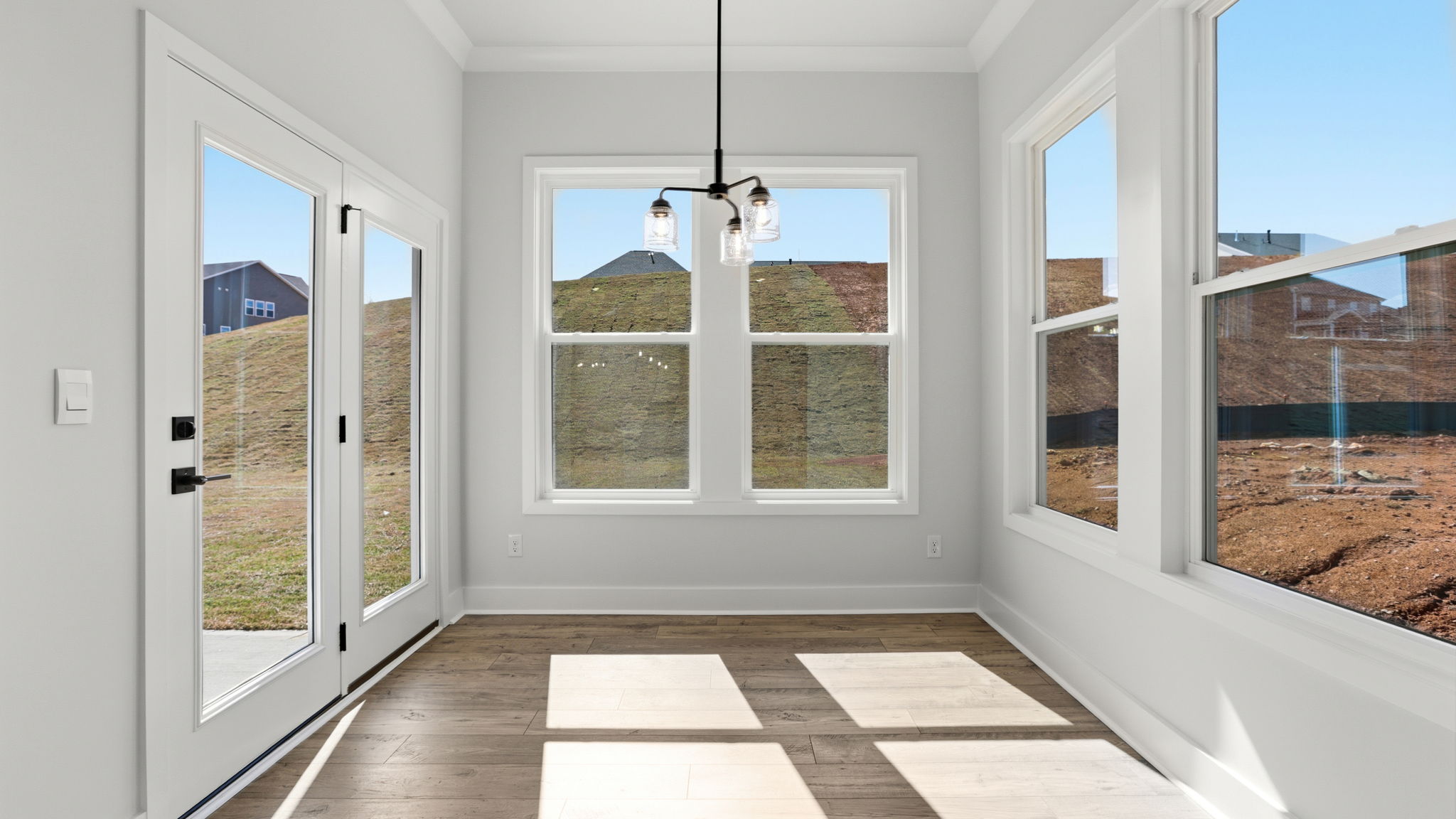 Breakfast room has all glass walls and the door to the covered porch.