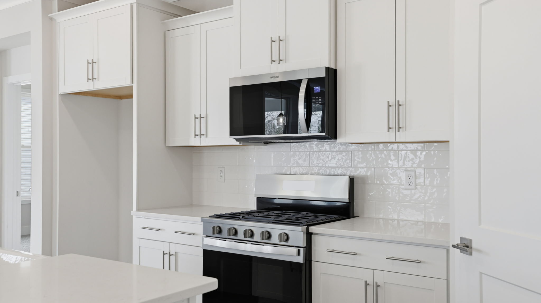 Kitchen features stainless steel appliances.