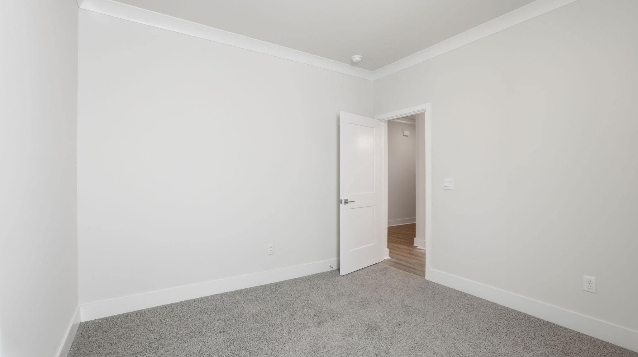 Bedroom with window and carpet.