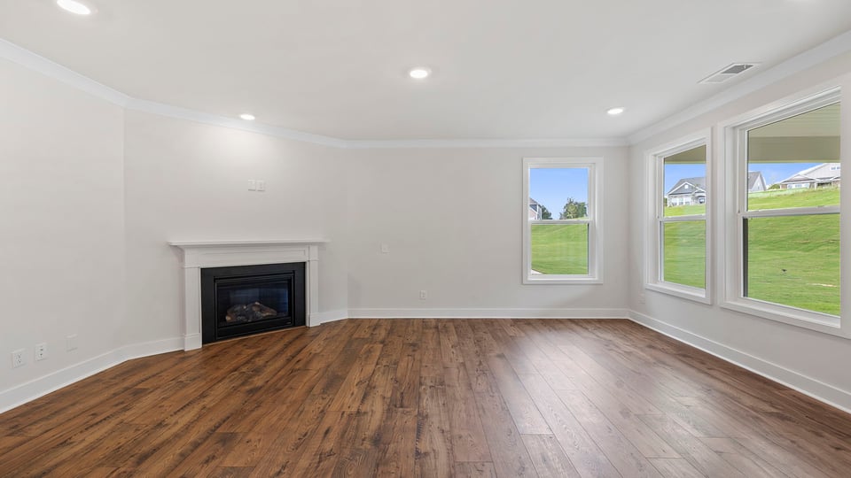 Living area with fireplace and windows.