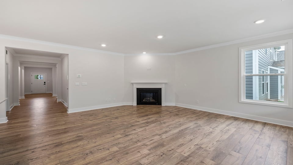 Living area with fireplace and windows.