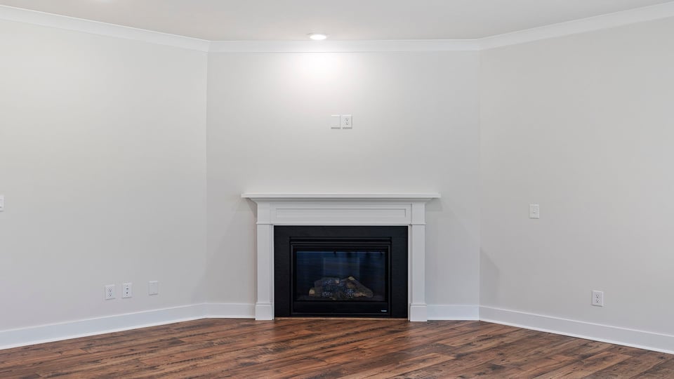 Living area with fireplace and windows.