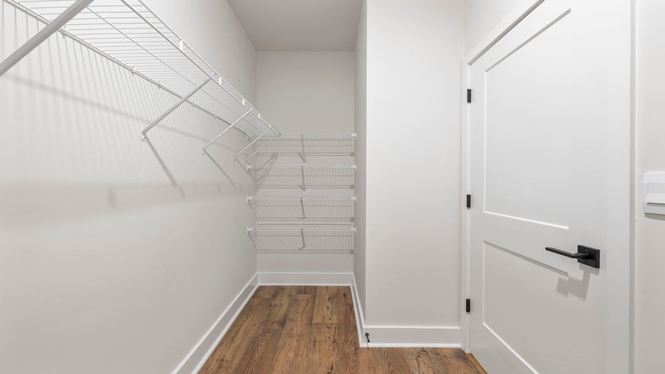 Primary closet with shelf.