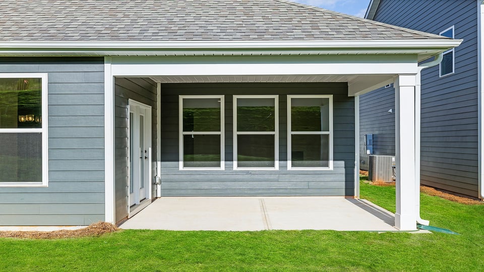Covered patio with large backyard.