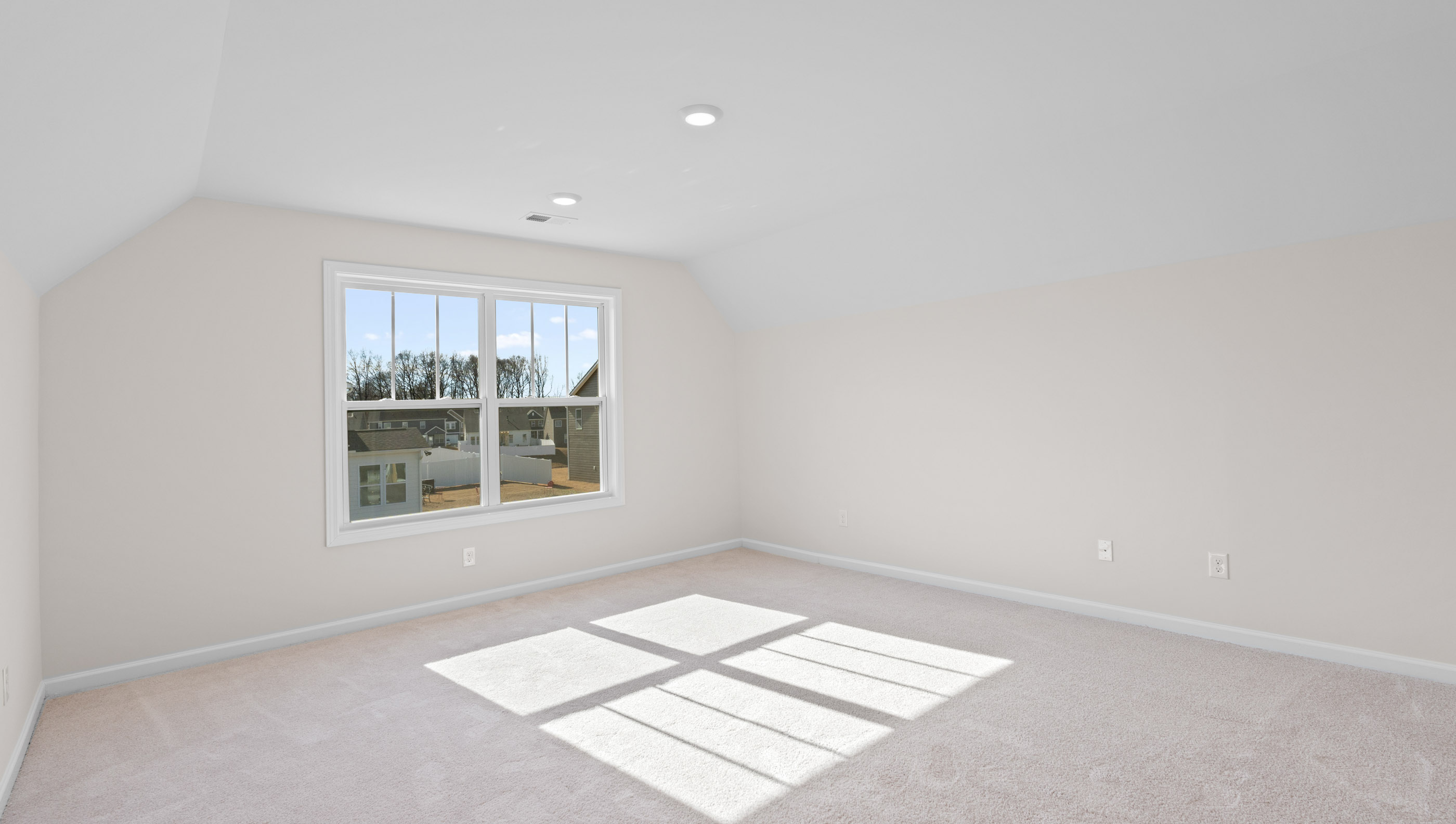 Bedroom with carpet and windows.