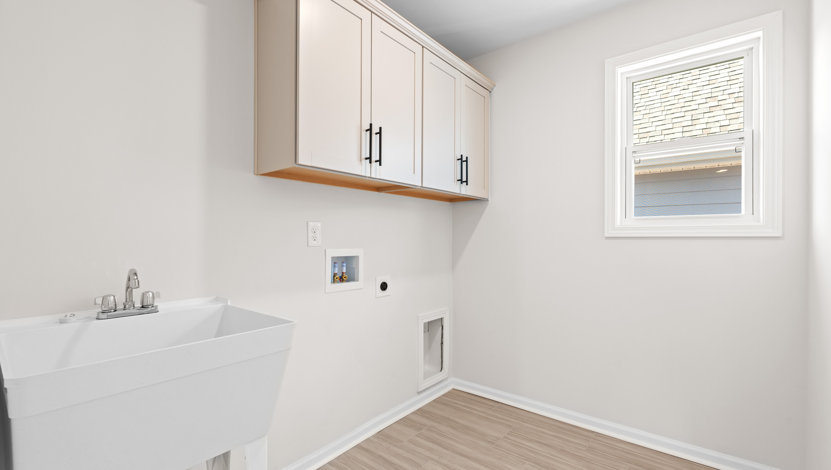 Laundry room with cabinets.