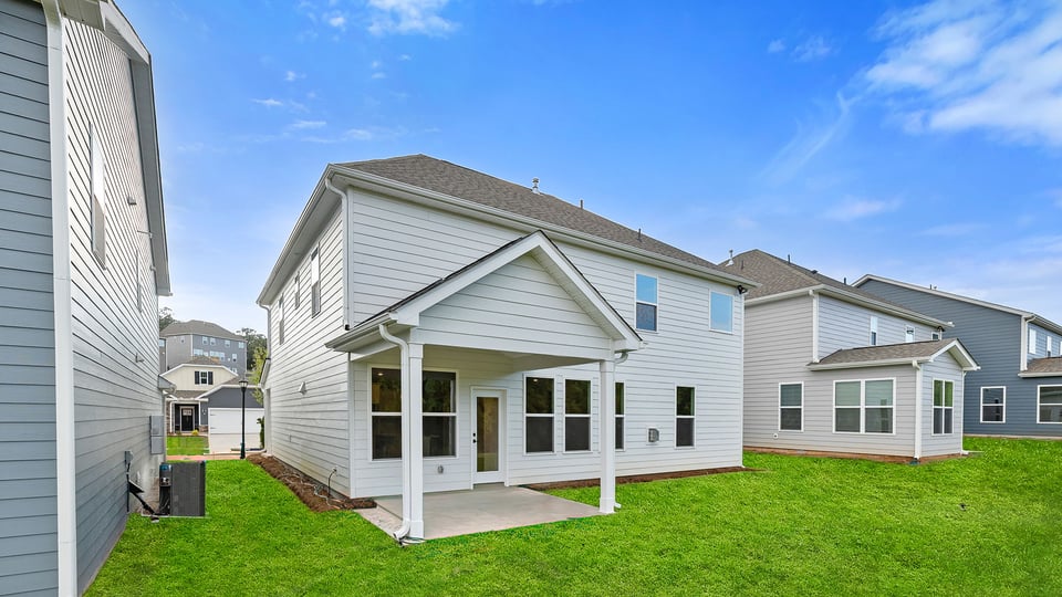 Back exterior with large backyard and patio.