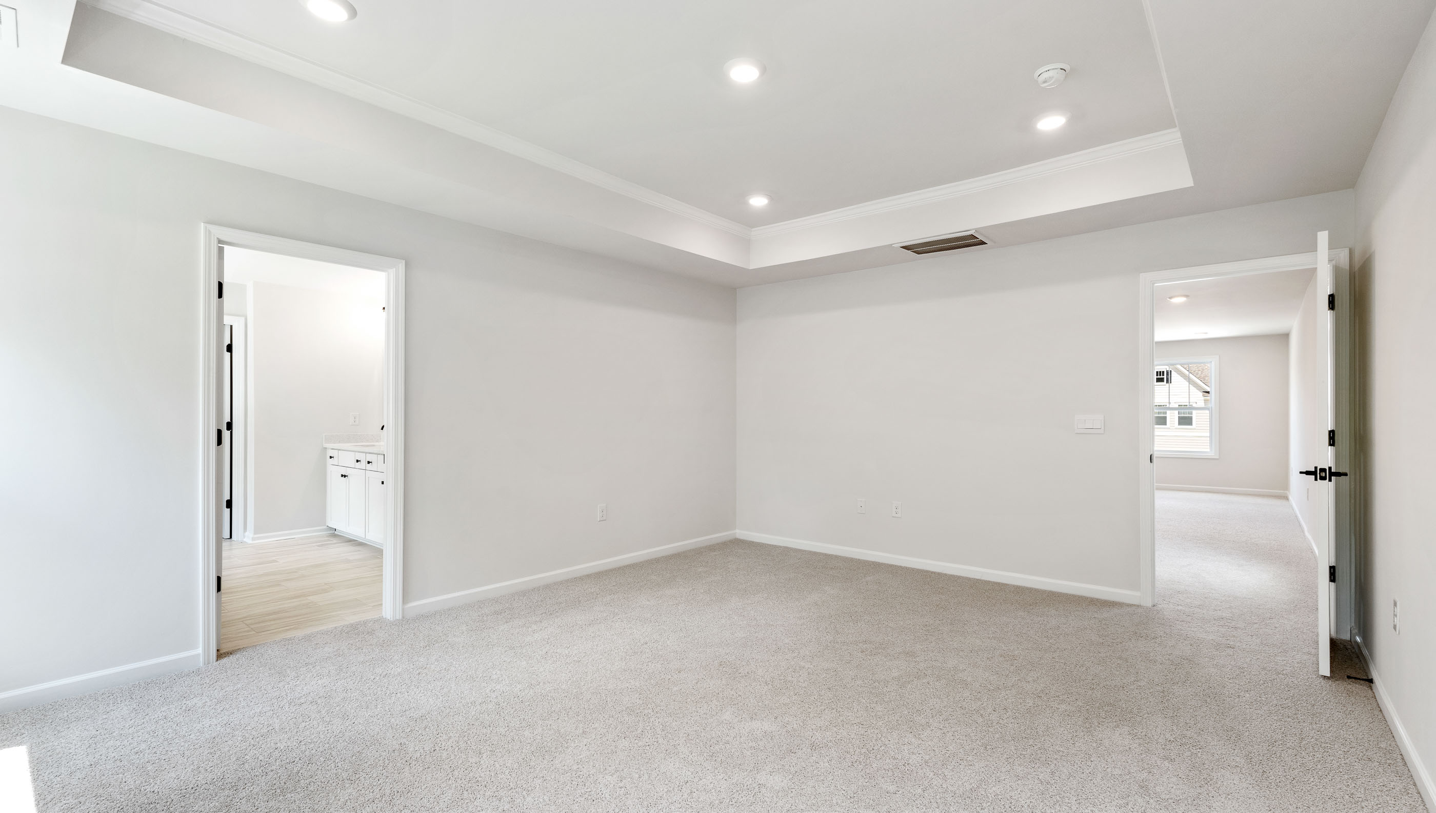 Trey ceiling with recessed lights.