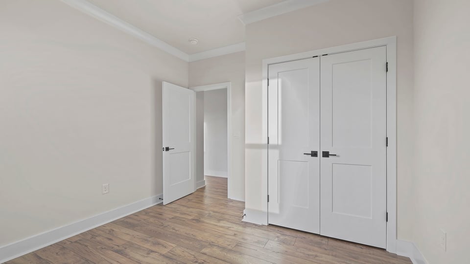 Bedroom with closet and windows.