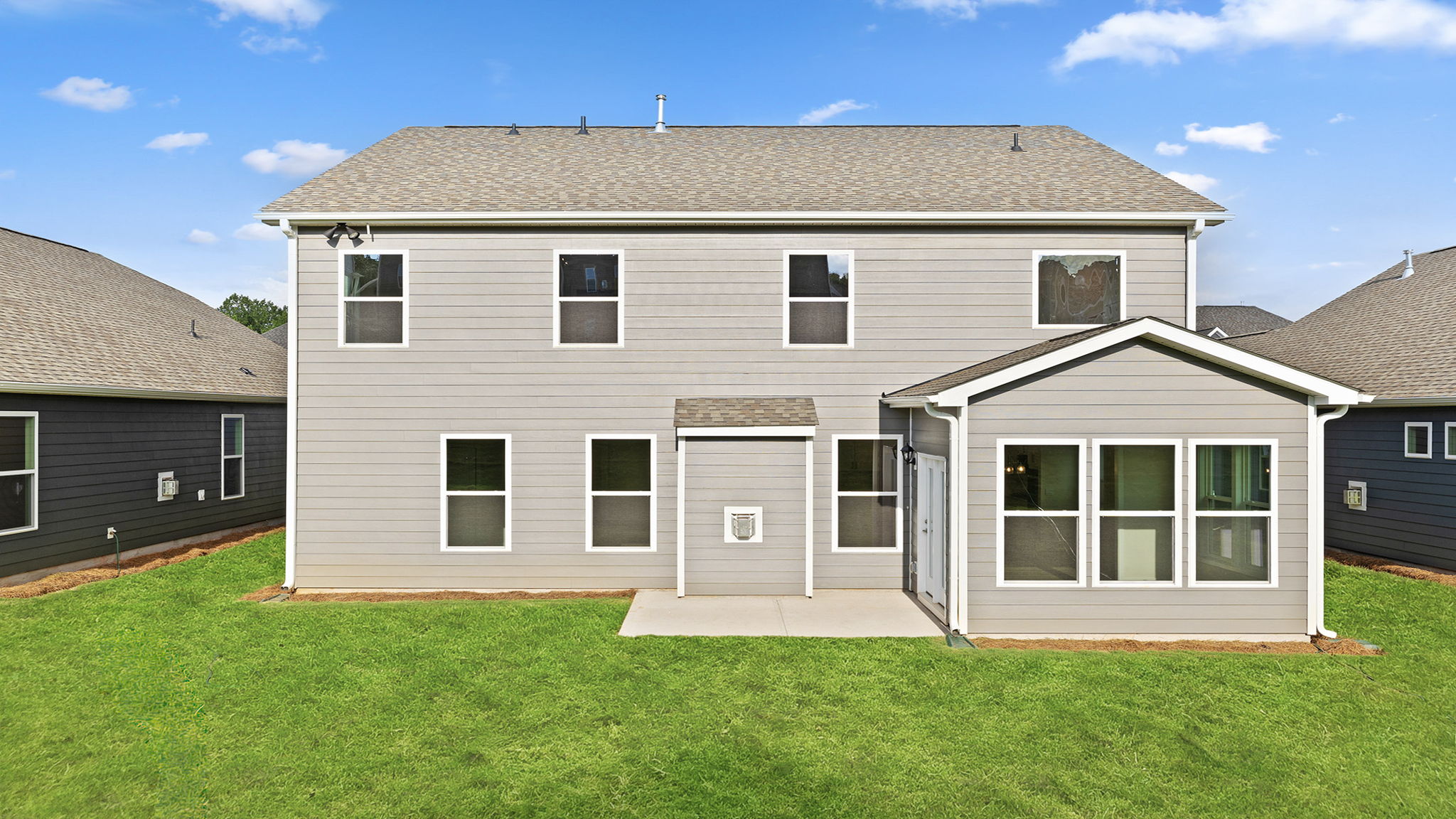 Back view of the Hampshire home patio and sunroom.