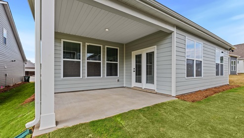 Back exterior of home with covered patio.