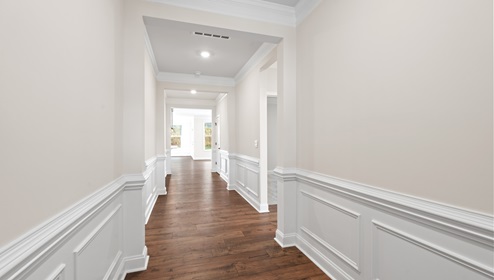 Hallway into home with view of rooms.