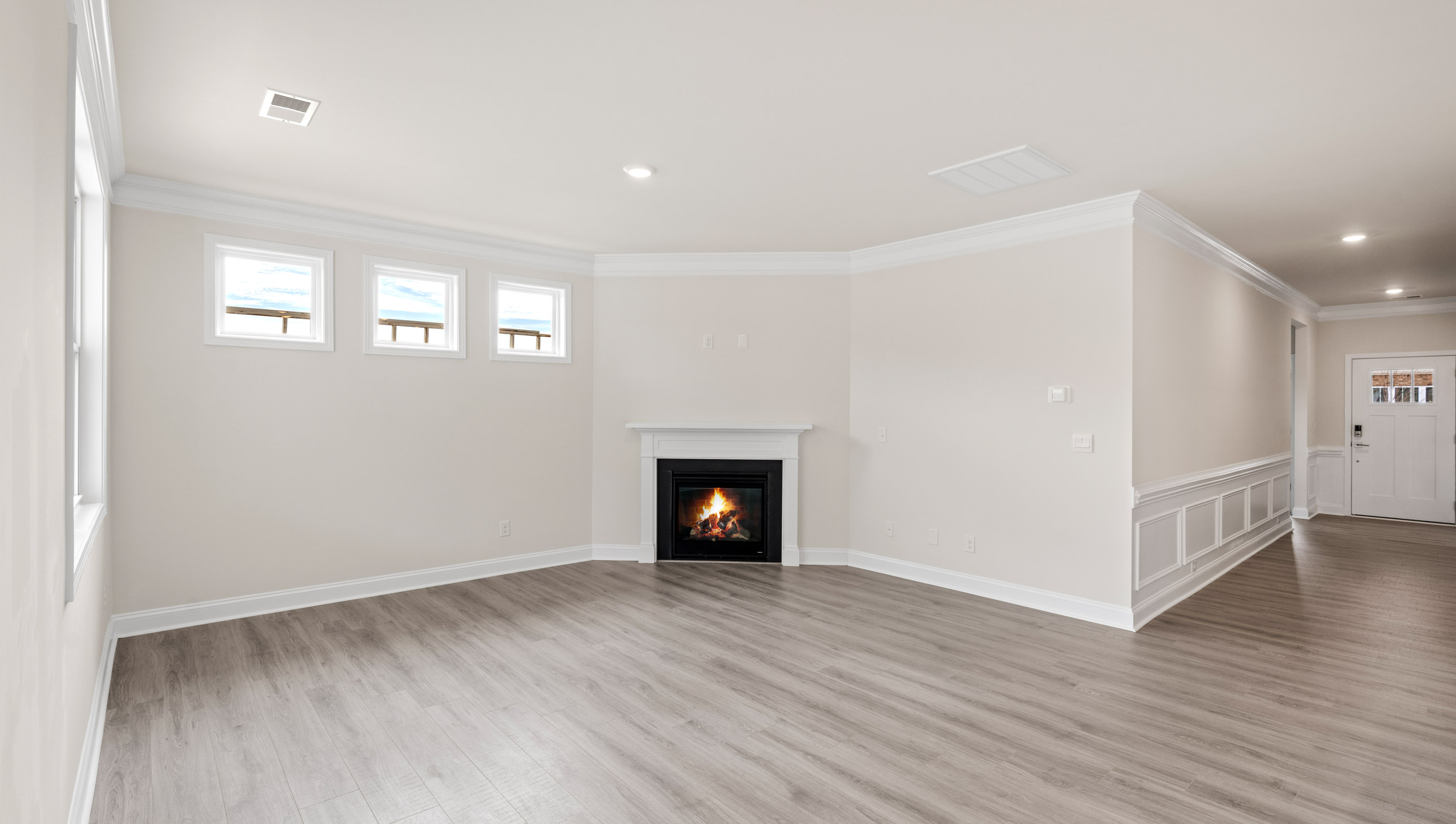 Living area with fireplace and windows.