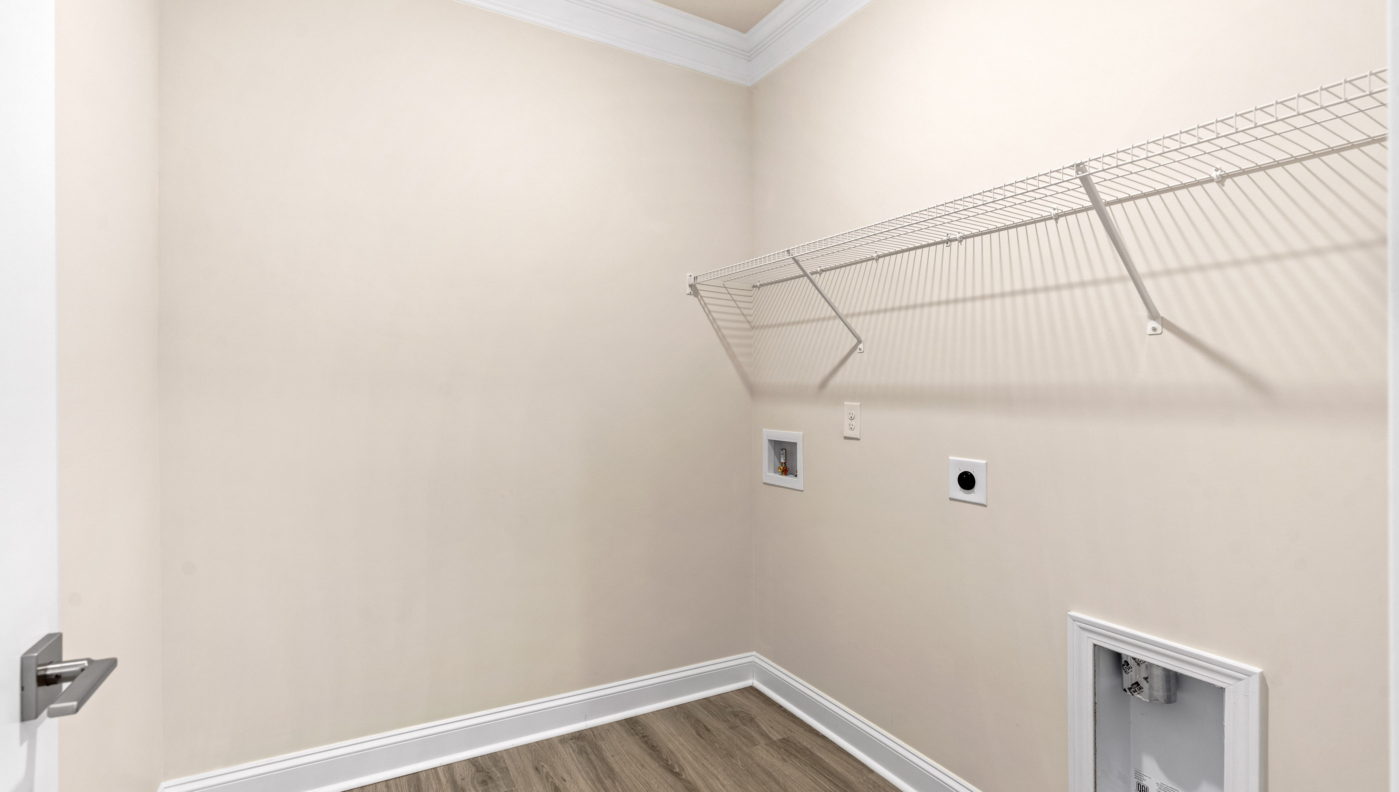 Laundry room with shelf.