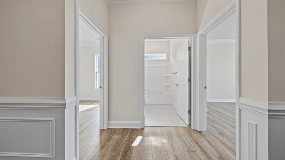 View of the hallway and view of hall bathroom and bedroom.