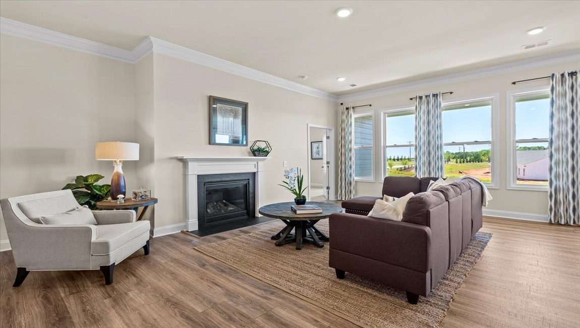 Living room with fireplace and windows.