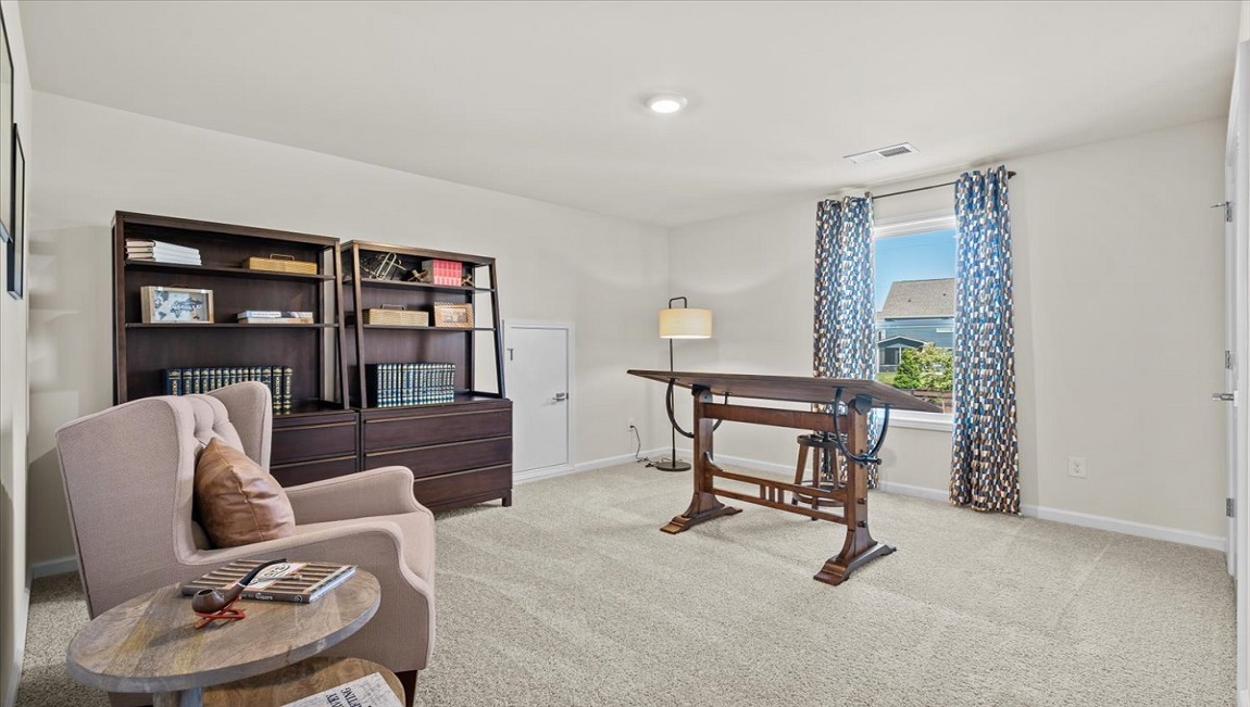 Bedroom with carpet and window.