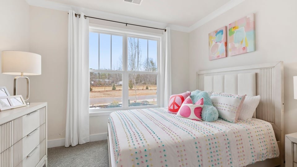 Bedroom with carpet and windows.