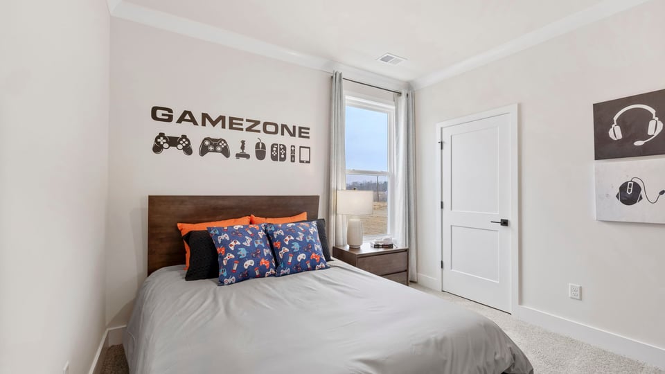 Bedroom with carpet and windows.