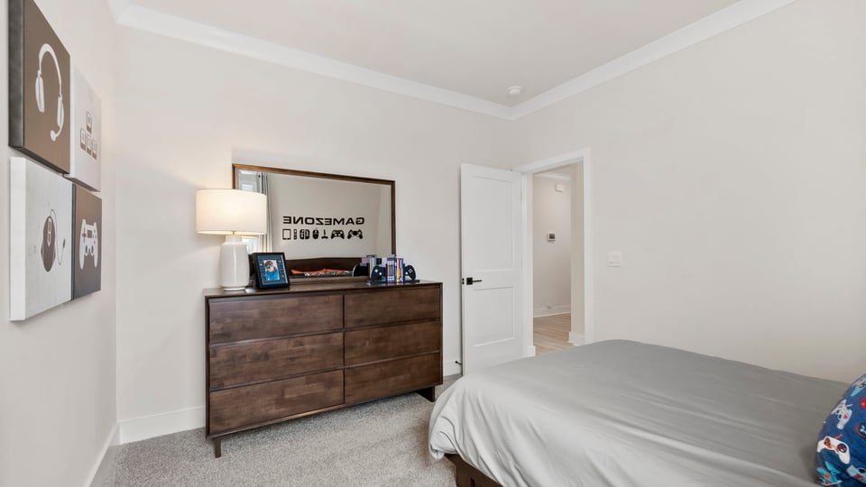 Bedroom with carpet and windows.