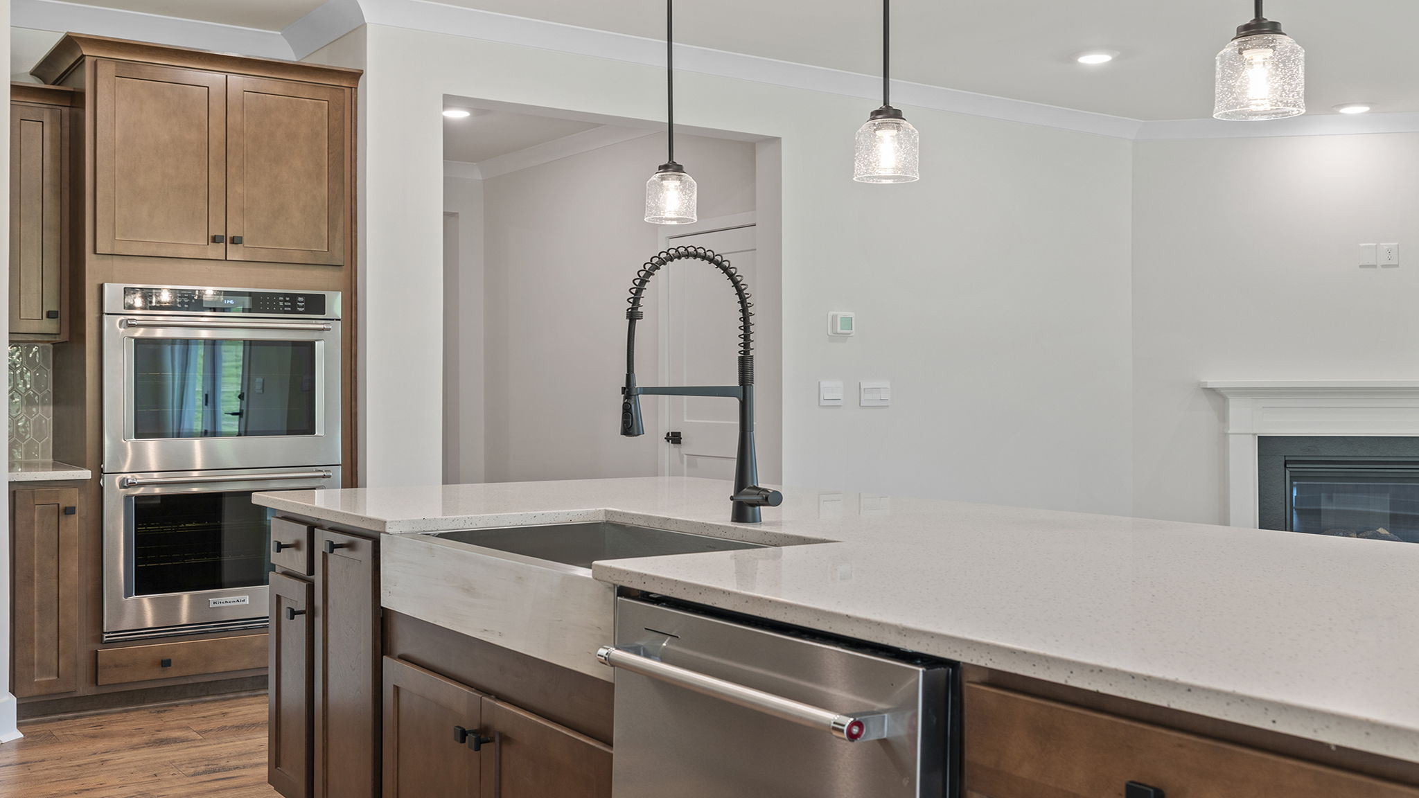 Deep sink in island with wall ovens.