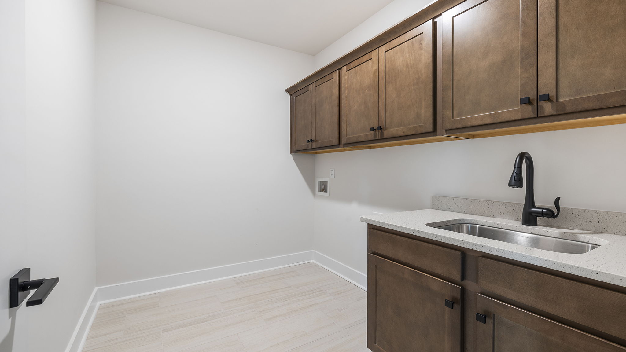 Laundry room with cabinets and sink.