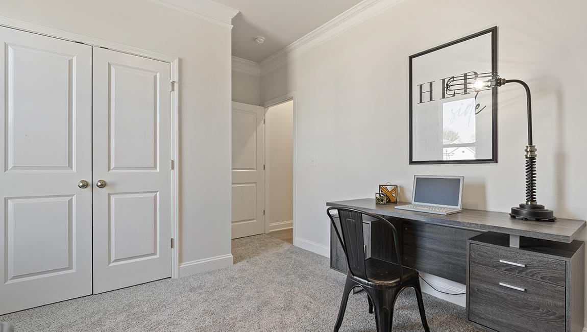 Bedroom with carpet and window.