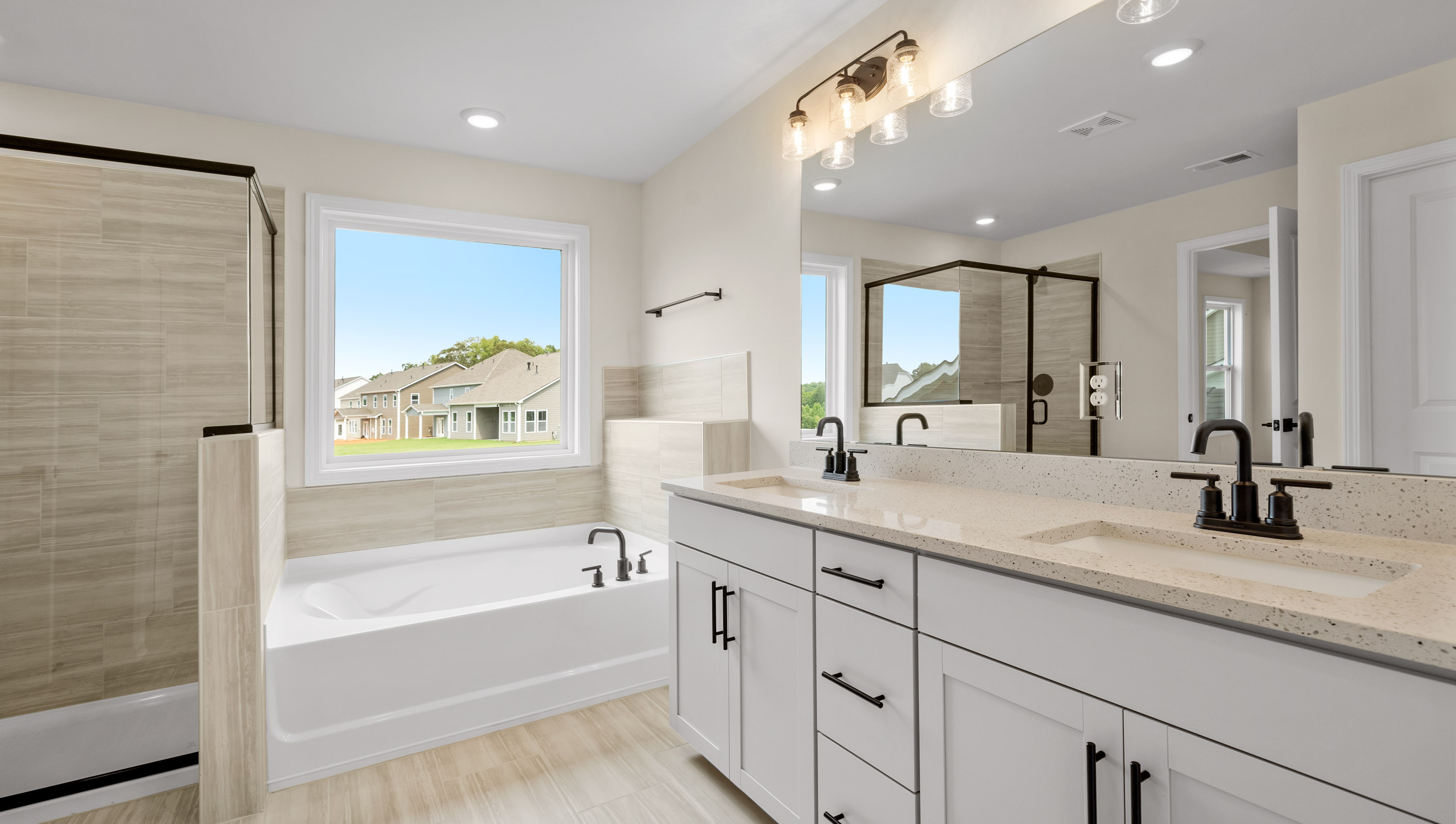 Primary bathroom with tub and walk-in shower.