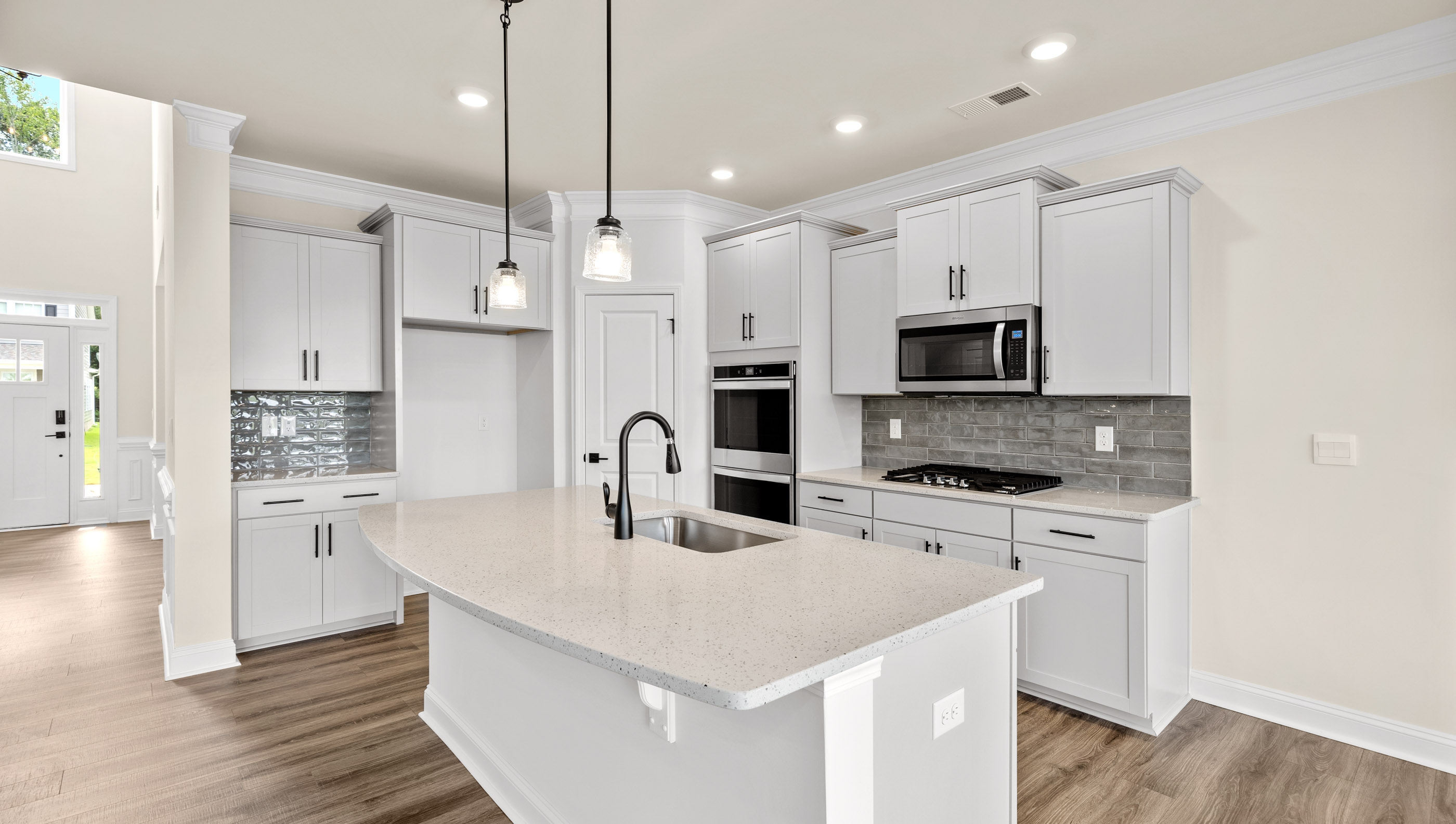 Kitchen with island and cabinets.