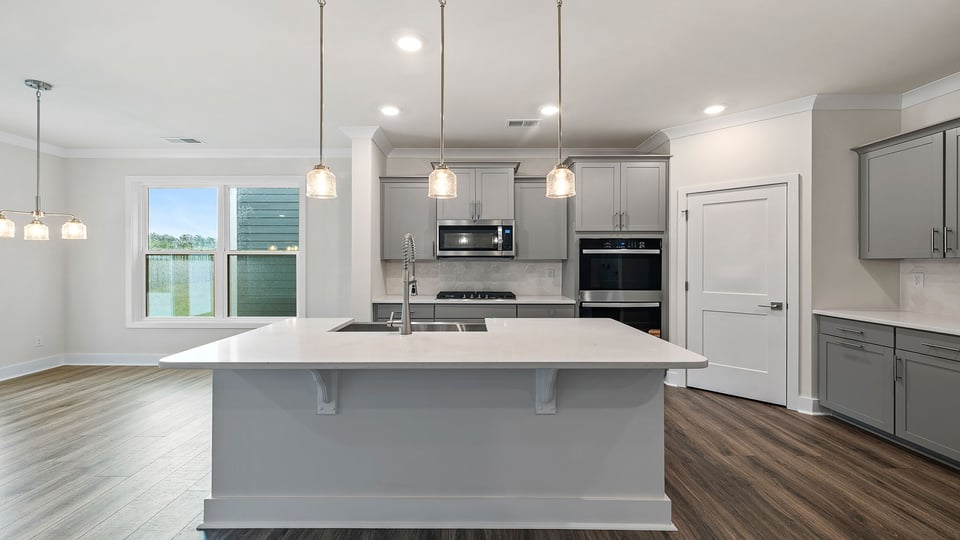 Kitchen with pendulum lighting.