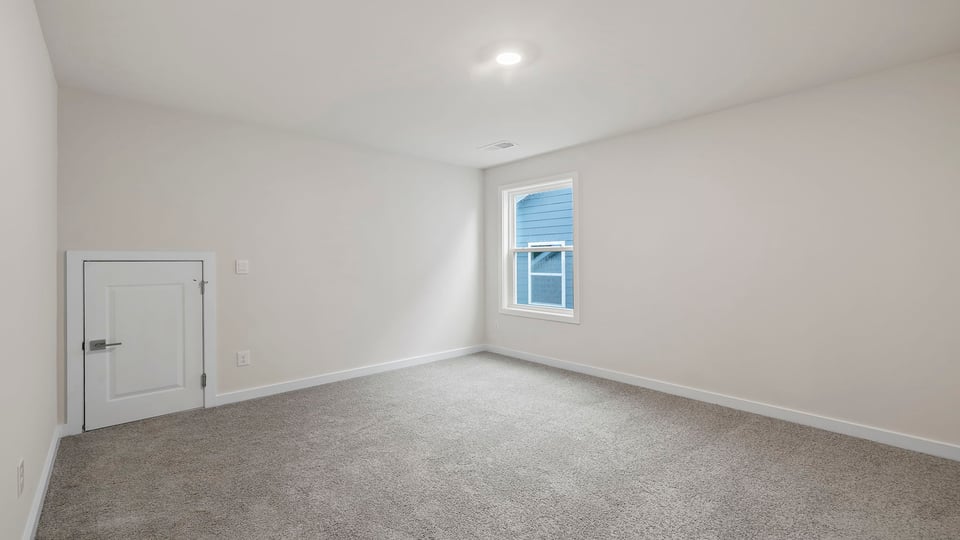 Bedroom with window and carpet.