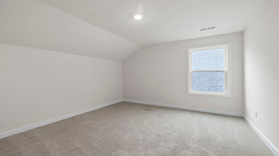 Bedroom with windows and carpet.