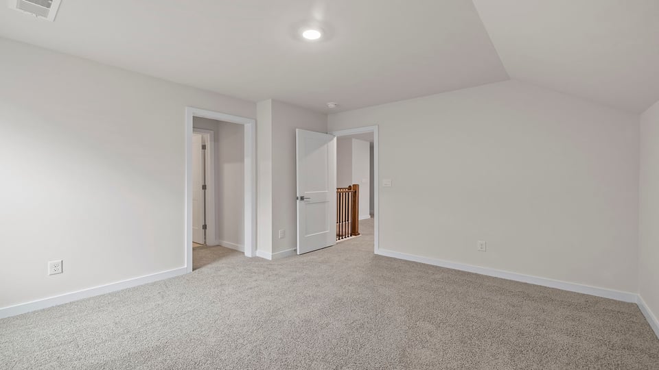 Bedroom with windows and carpet.