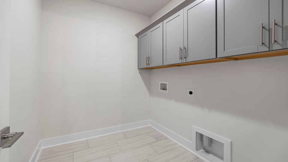 Laundry room on main level with cabinets.