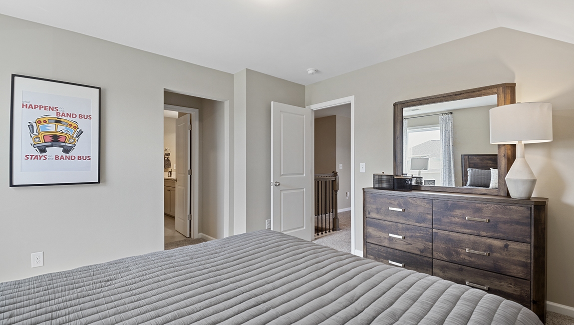 Bedroom with carpet and windows.