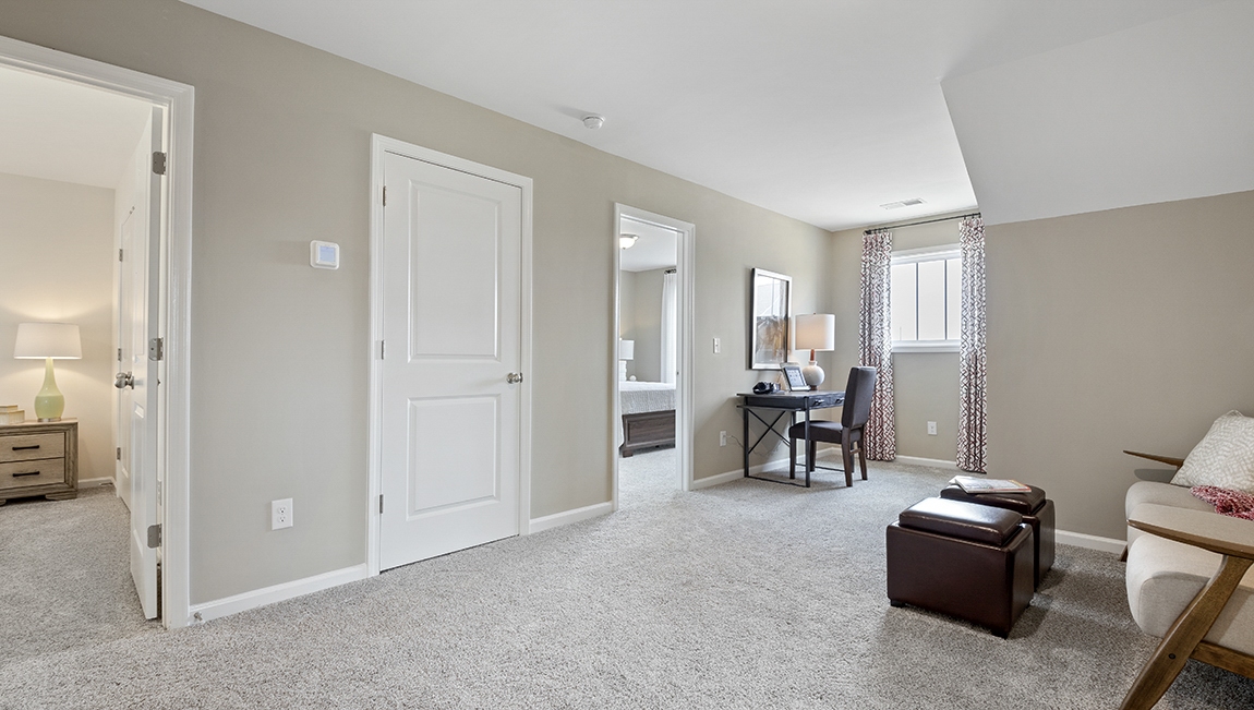 Loft area with carpet and window.