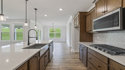 Kitchen with island and cabinets.
